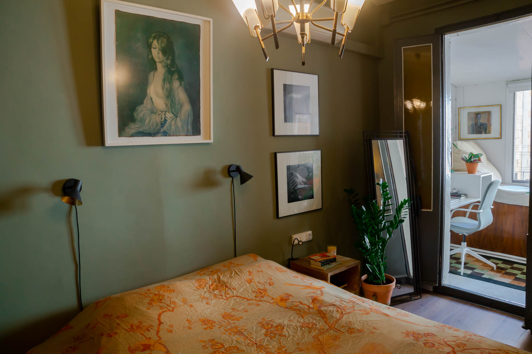 Barcelona home tour: sage green master bedroom with Hermes throw and vintage chandelier