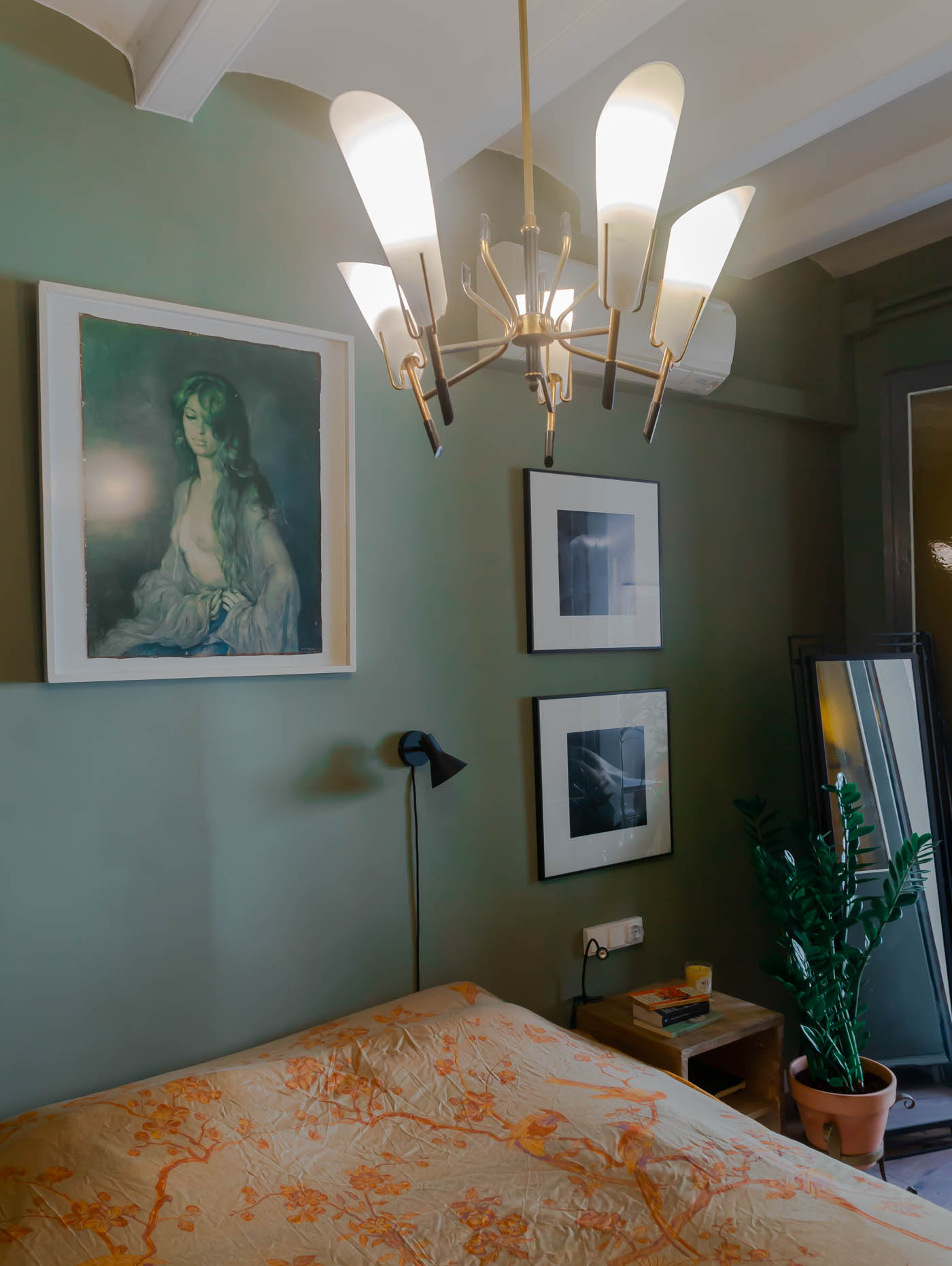 Barcelona home tour: sage green master bedroom with Hermes throw and vintage chandelier