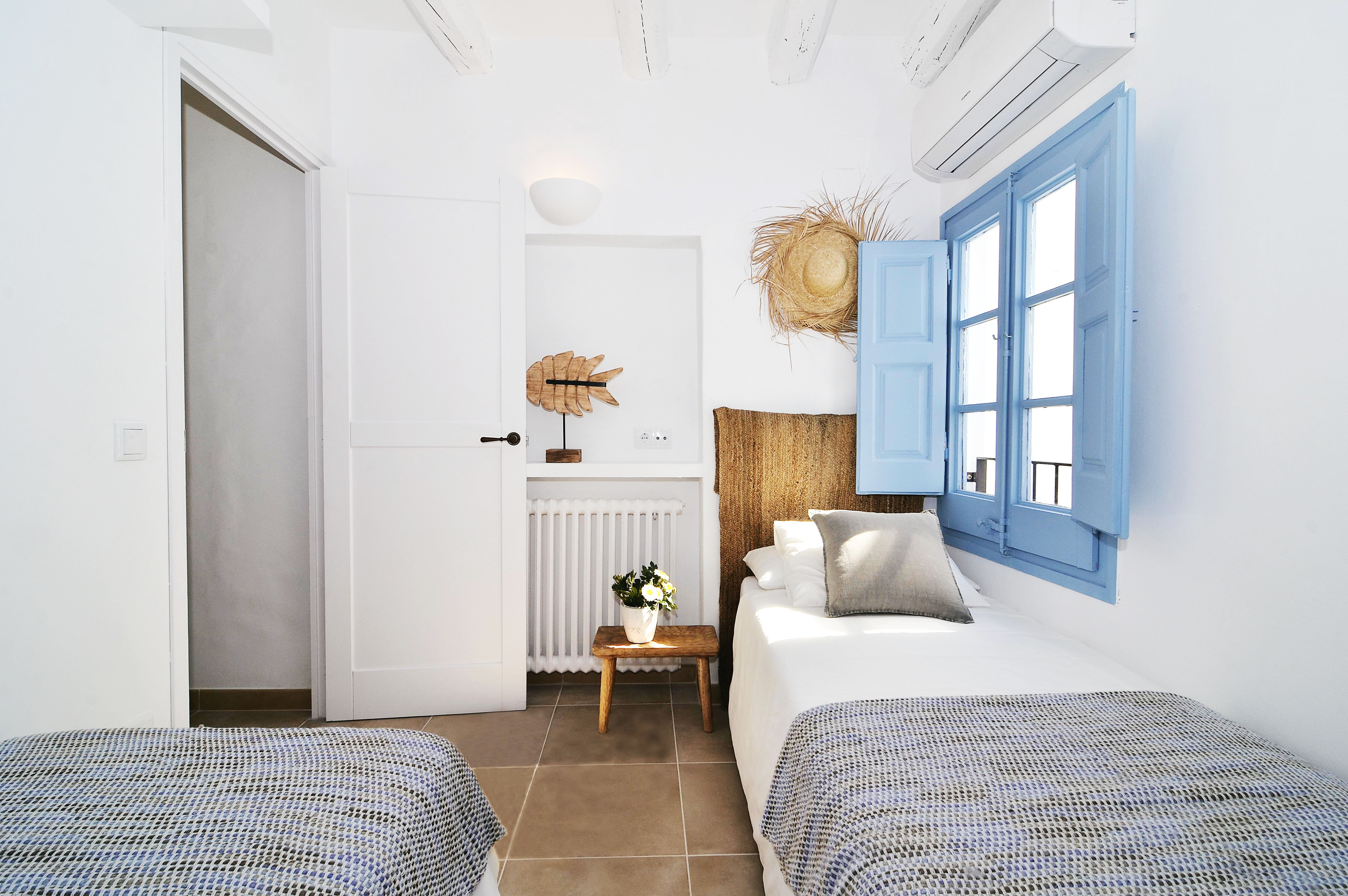 House tour: old fisherman's house in Sitges: bedroom with blue window