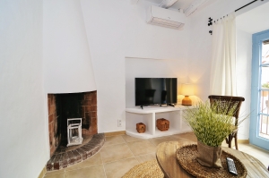 House tour: old fisherman's house in Sitges: sitting room with fireplace