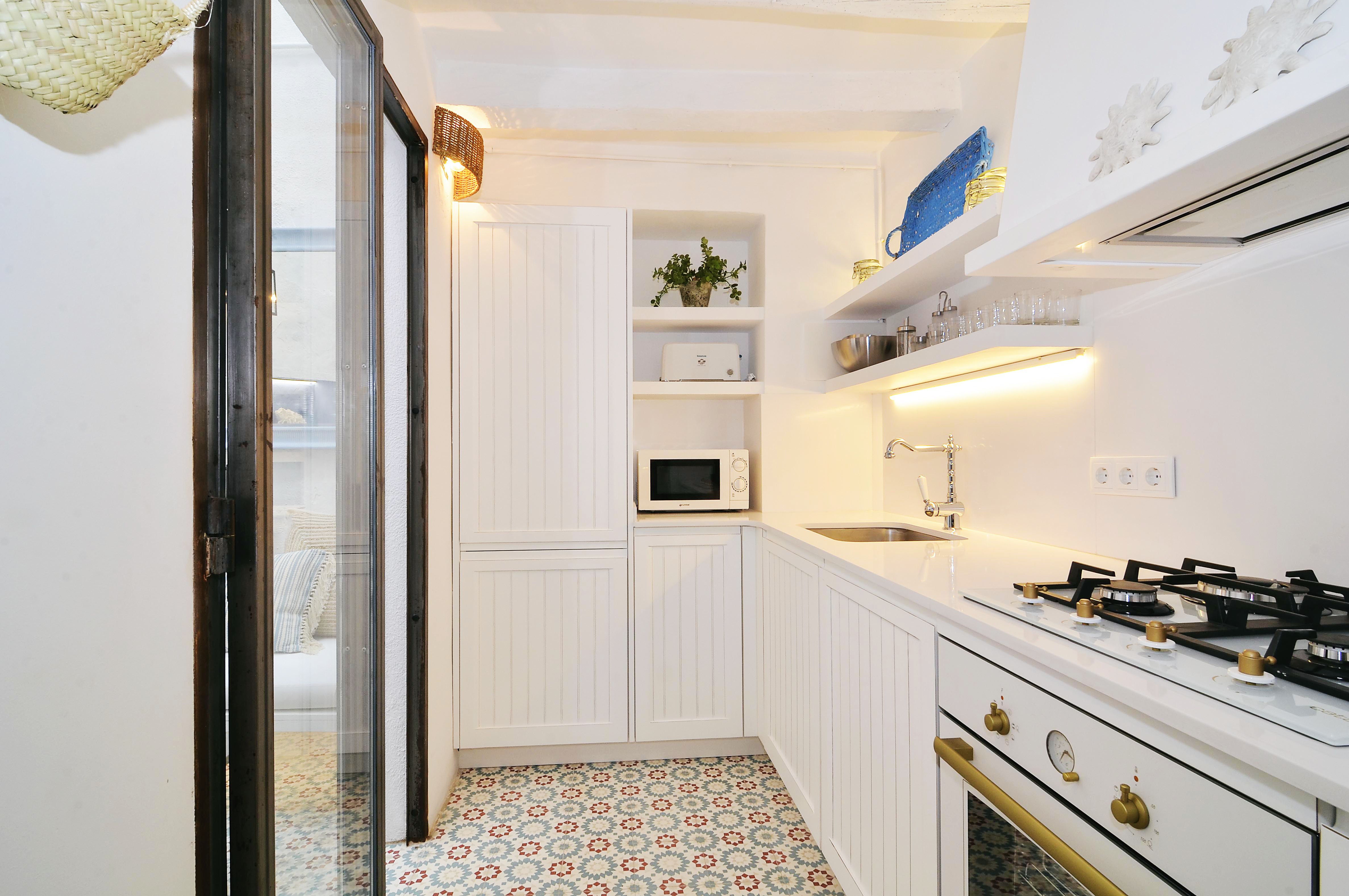 House tour: old fisherman's house in Sitges: white kitchen with tile floor