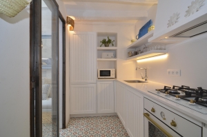 House tour: old fisherman's house in Sitges: white kitchen with tile floor