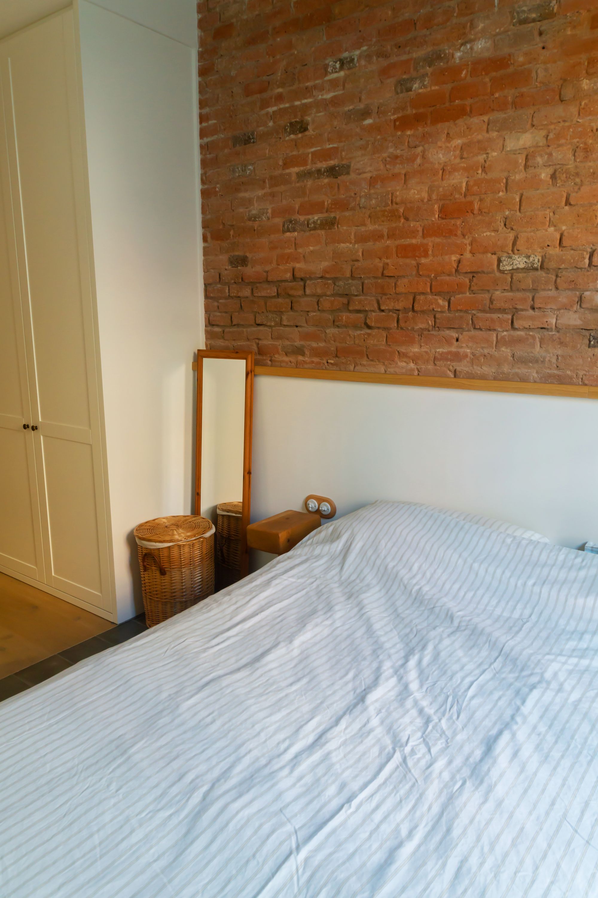 Gemma home tour Barcelona bedroom exposed brick wall