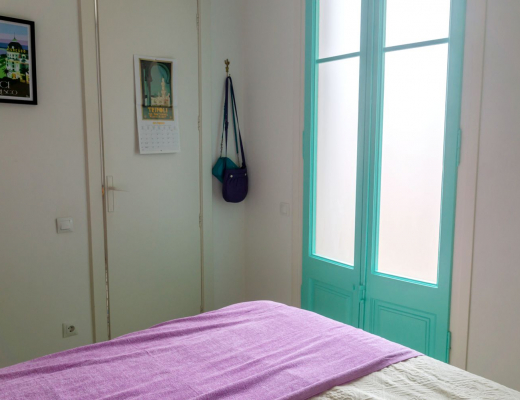 Turquoise balcony doors and lilac bed throw