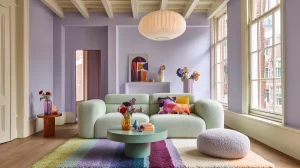 Eclectic dopamine living room with lilac wall and mint green sofa